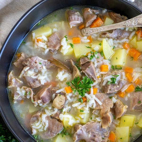 Chicken Gizzard soup in a bowl with a spoon