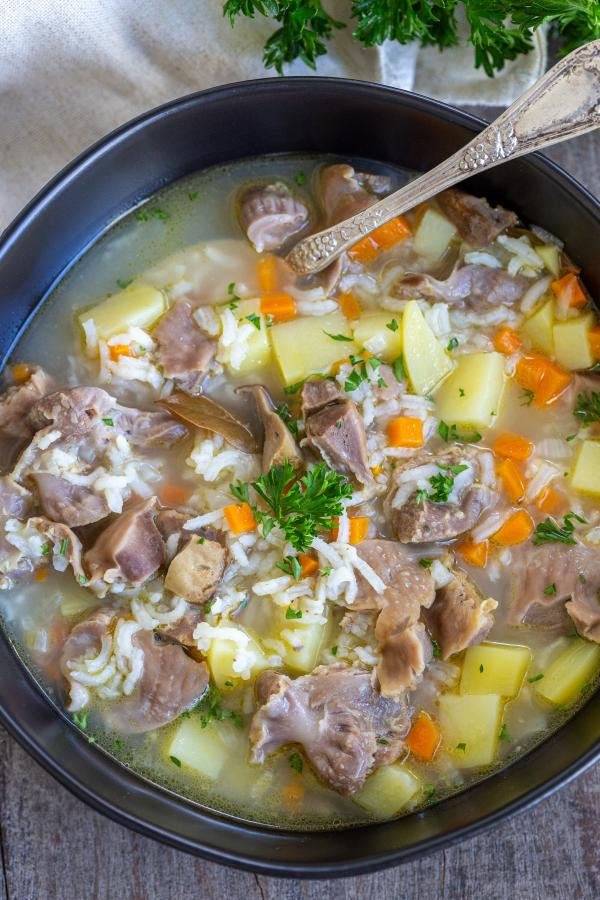 Chicken Gizzard soup in a bowl with a spoon