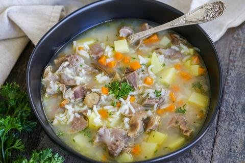 Chicken Gizzard soup in a bowl with a spoon