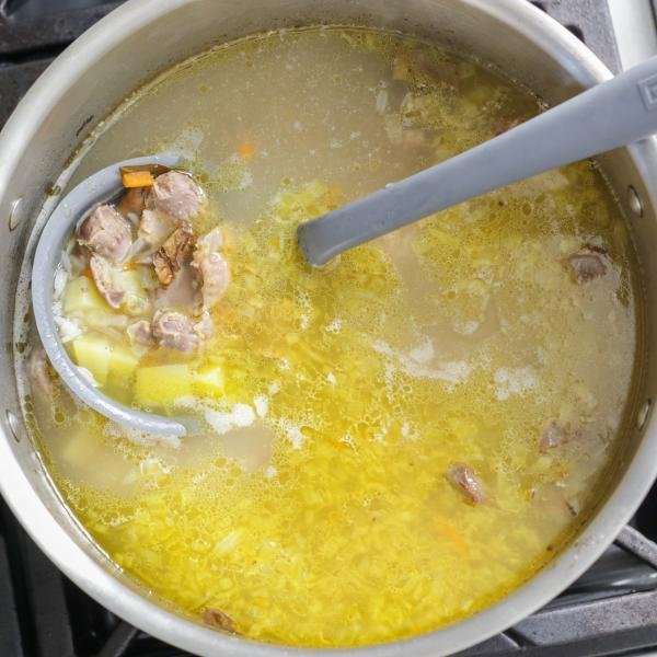 pot of chicken gizzard soup with ladle