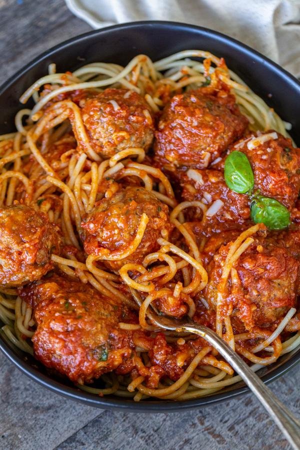 Meatballs with spaghetti and marinara sauce in a bowl 