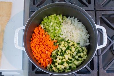 zucchini, onion, celery and carrots in a pot