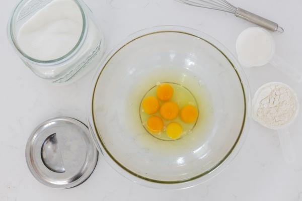 eggs in a bowl with sugar and flour
