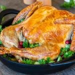 Roasted turkey in a pan with herbs