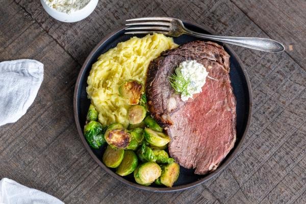 Serving plate with prime rib, mashed potatoes and veggies