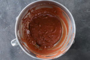Melted chocolate, eggs and sugar in a bowl.
