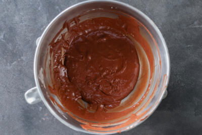Melted chocolate, eggs and sugar in a bowl.
