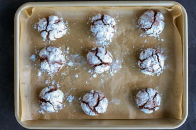 Baked Chocolate Crinkle Cookies on a baking sheet.