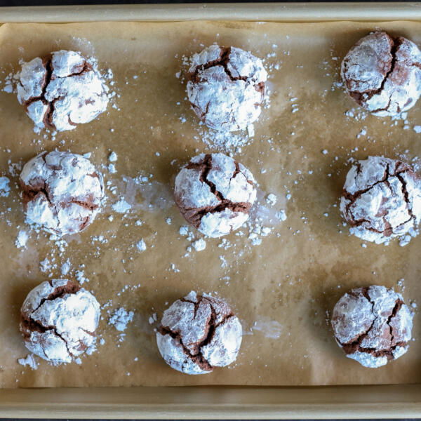 Baked Chocolate Crinkle Cookies on a baking sheet.