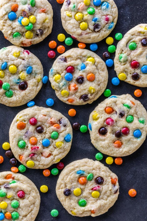 M&M Cookie next to each other with candy around. 