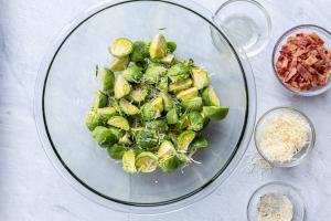 Cut Brussels Sprouts in a bowl with seasoning