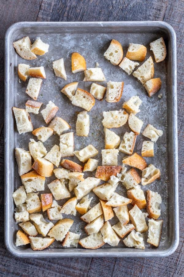 Bread pieces for croutons on a baking sheet