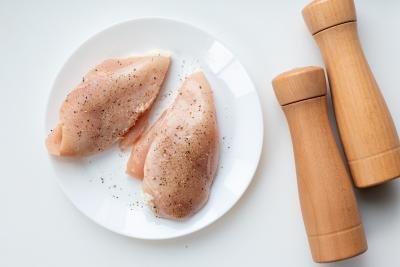 Chicken breast on a plate with salt and pepper