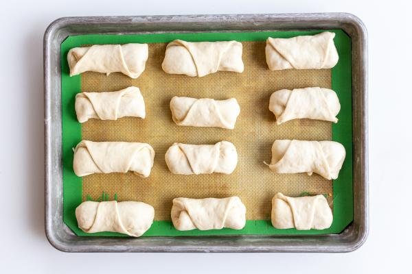 Unbaked pizza rolls on a baking sheet