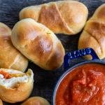 Baked pizza rolls and sauce on the side