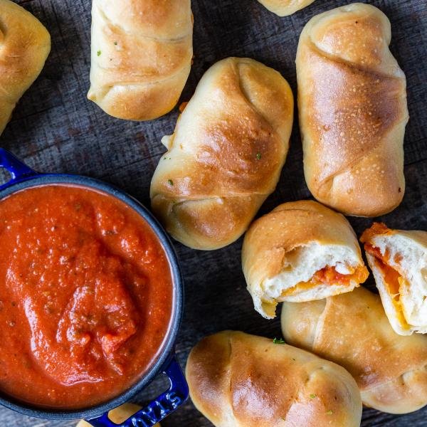 Baked pizza rolls and sauce on the side