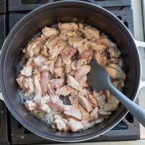 Chicken is getting cooked in a pan