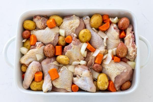 baking sheet with chicken and potatoes