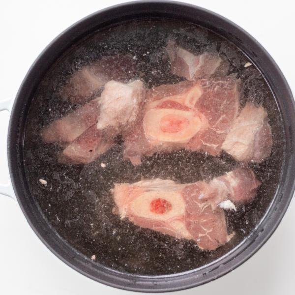 meat in a pot with borscht