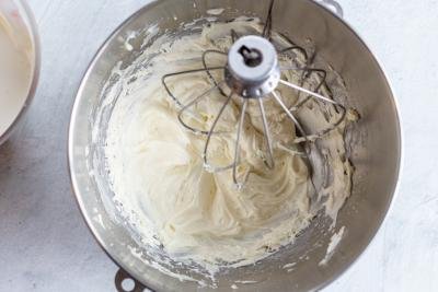 whisked cream in a mixing bowl