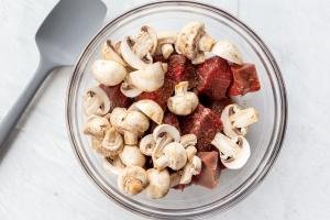mushrooms and steak in a bowl