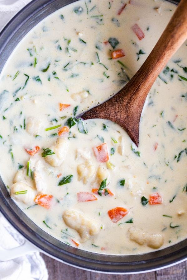 A bowl of chicken gnocchi soup in a pot