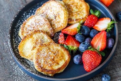 Cottage cheese pancakes on a plate with berries