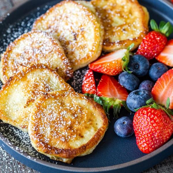 Cottage cheese pancakes on a plate with berries