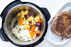 Instant pot with veggies and browned beef next to it