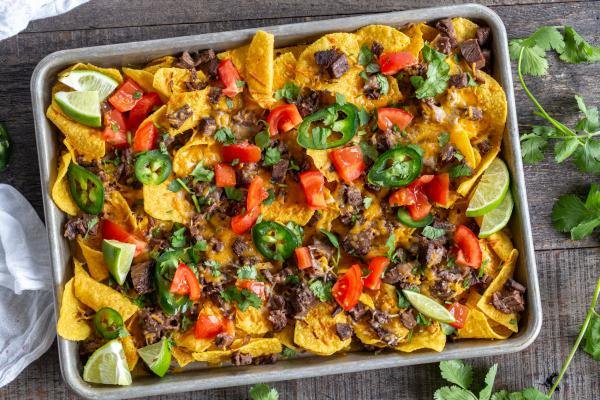 Nacho tray with chips, cheese, veggies and beef