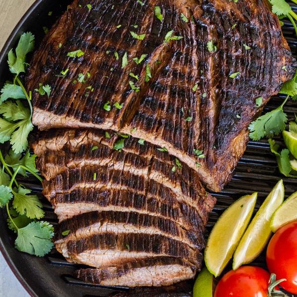 Sliced carne asada on the grilling pan