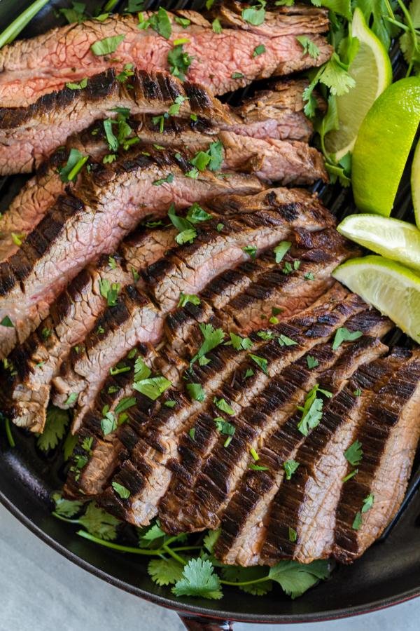 Sliced carne asada on the grilling pan