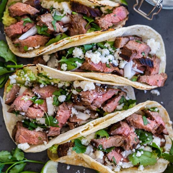 carne asada street tacos on a serving tray