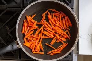 carrots getting browned in a skillet