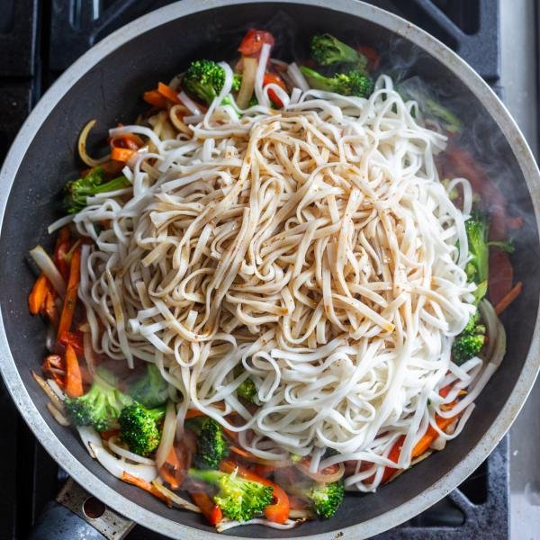 Noodles and sauce added to a skillet