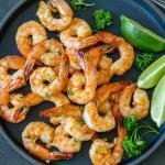 Air Fryer shrimp on a plate with herbs
