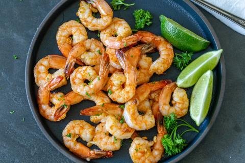 Air Fryer shrimp on a plate with herbs