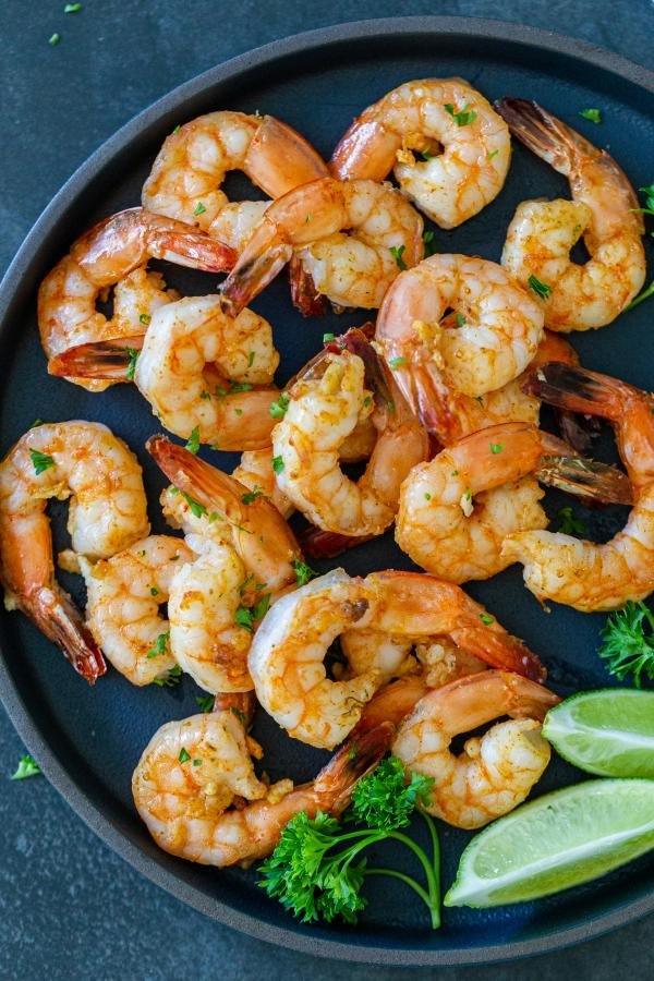 Air Fryer shrimp on a plate with herbs