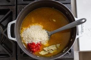 broth and rice and in a pot with tomato paste and bay leaves