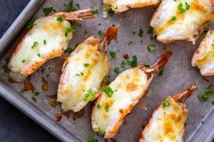 baked shrimp with cheese o a baking sheet