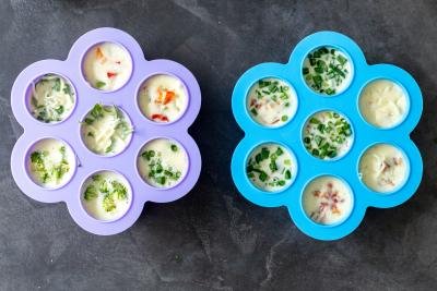 Two molds with eggs and veggies