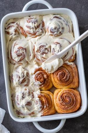 cinnamon rolls with cream cheese on top