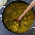 pot of sorrel soup with a scoop