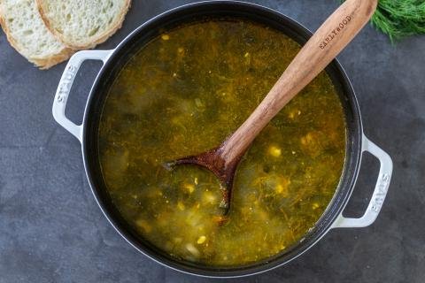 pot of sorrel soup with a scoop