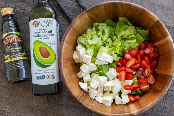 balsamic vinegar and oil next to the salad