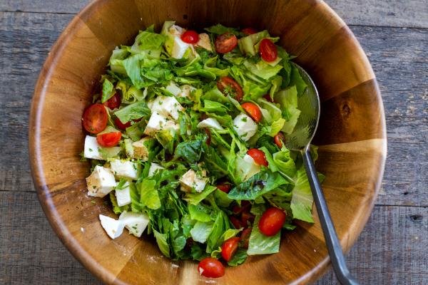 salad tossed together in a bowl