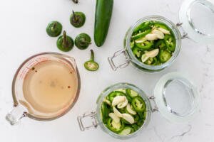 sliced Jalapenos with marinade and jars