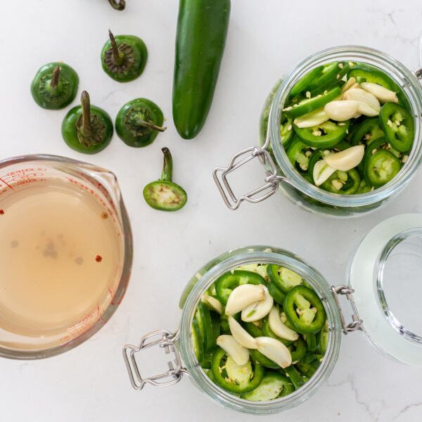 sliced Jalapenos with marinade and jars