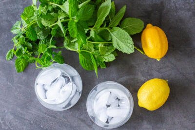 Cups with ice and lemon and mint