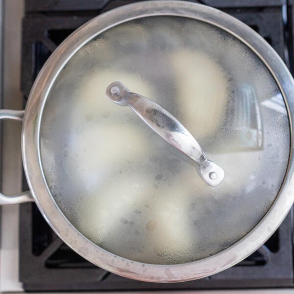 pot covered with pierogi inside